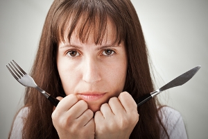 Woman with fork and knife