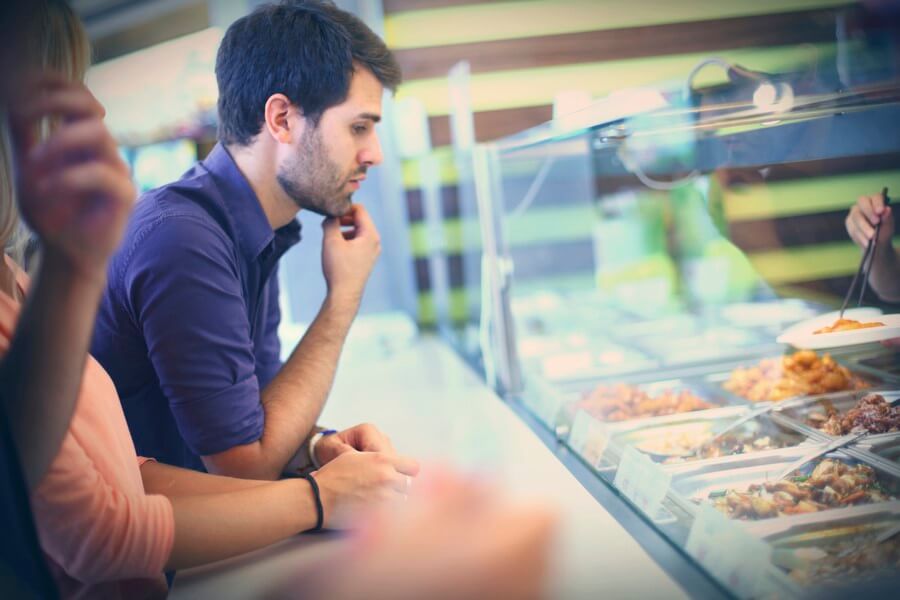 Man looking at food in the buffet line