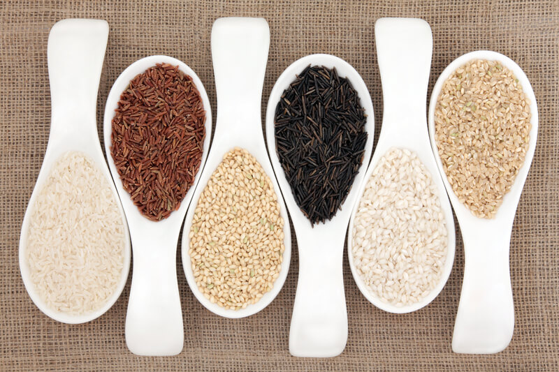 Rice varieties in white spoons