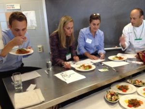 The four judges sample the food in front of them.