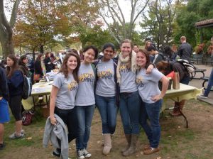 A group of students standing arm-in-arm.