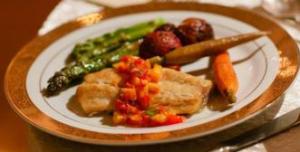 Sea bass on a plate with vegetables.