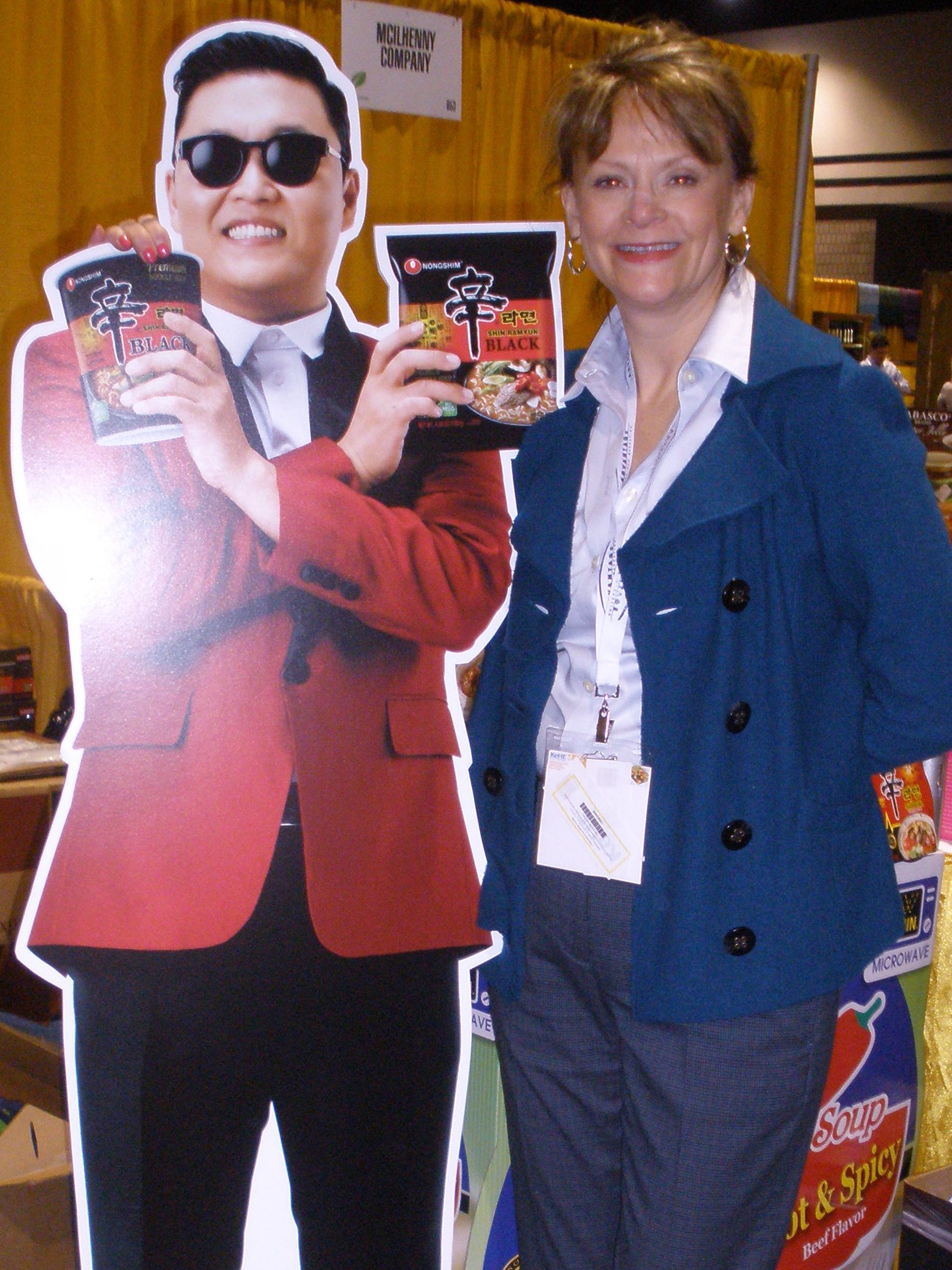 Beckee standing next to a cardboard cutout of Psy