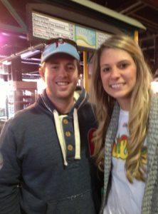 Two smiling fans standing next to each other.