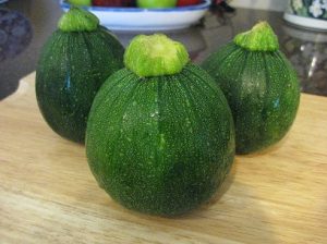 Three raw, uncooked zucchinis