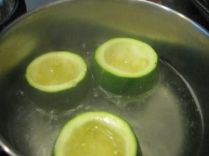 Zucchini boiling in a pot of water.