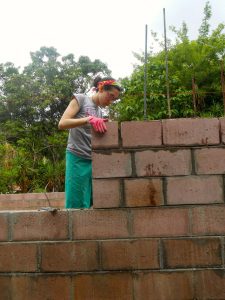 Candice laying bricks.
