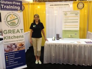 Beckee standing at the at the GREAT Kitchens booth at the event.