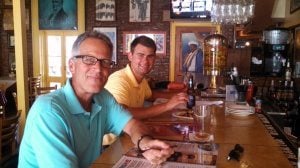 Dave and Cole sitting at the booth of a restaurant.