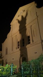 Shadow of a human figure against the side of the building. 