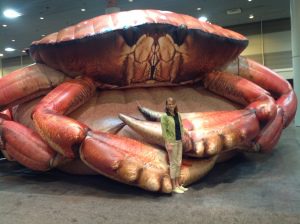 Beckee standing in front of a giant crab. 