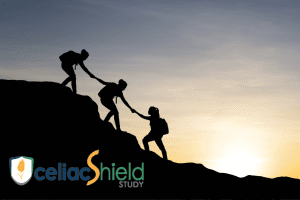 Silhouettes of three hikers climbing a hill at sunset, helping each other upward. The celiacShield STUDY logo is in the lower left corner.