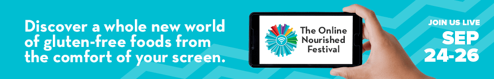 A hand holds a smartphone displaying The Online Nourished Festival logo. Text reads: Discover a whole new world of gluten-free foods from the comfort of your screen. Event dates: Sep 24-26. Blue zigzag background.