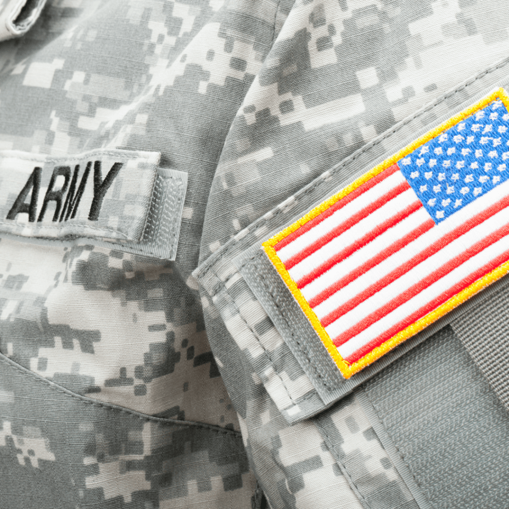 A close-up of a military uniform, including a badge of the American flag