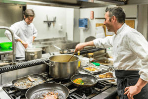 Two chefs cooking in a restaurant kitchen