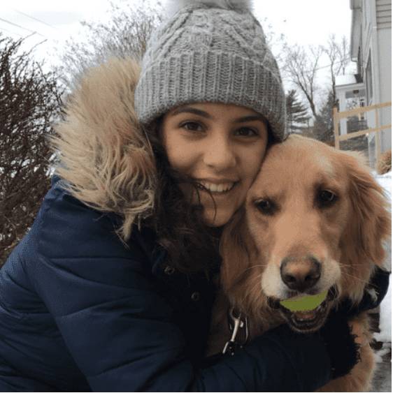 Portrait of Rachel with her dog, a golden retriever