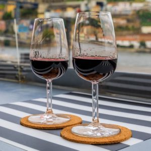 Two wine glasses with port on a table.