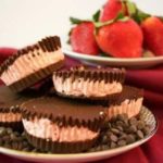 A plate of strawberry chocolate cups. 
