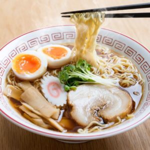 A bowl of ramen with chopsticks.