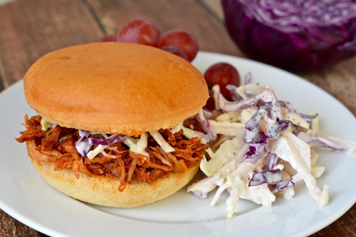 A pulled-pork sandwich with coleslaw. 