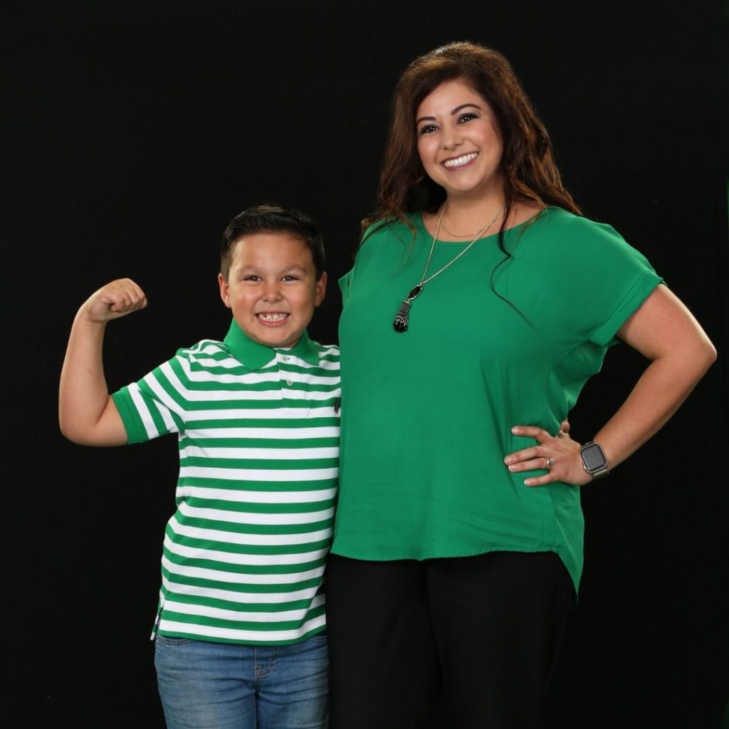 Mother and son side-hugging. Both are wearing green, the official color of celiac disease.