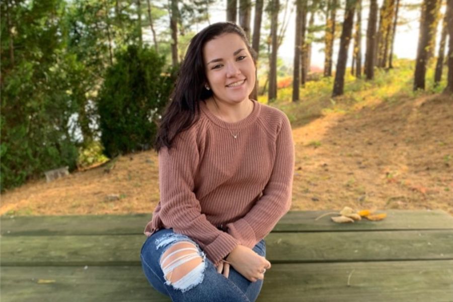 A photo of Alyssa sitting on a bench.