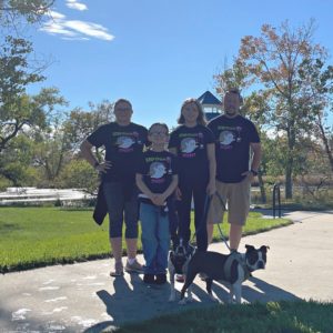 A group of four people and a dog wearing the Step Beyond Celiac 5K shirts. 