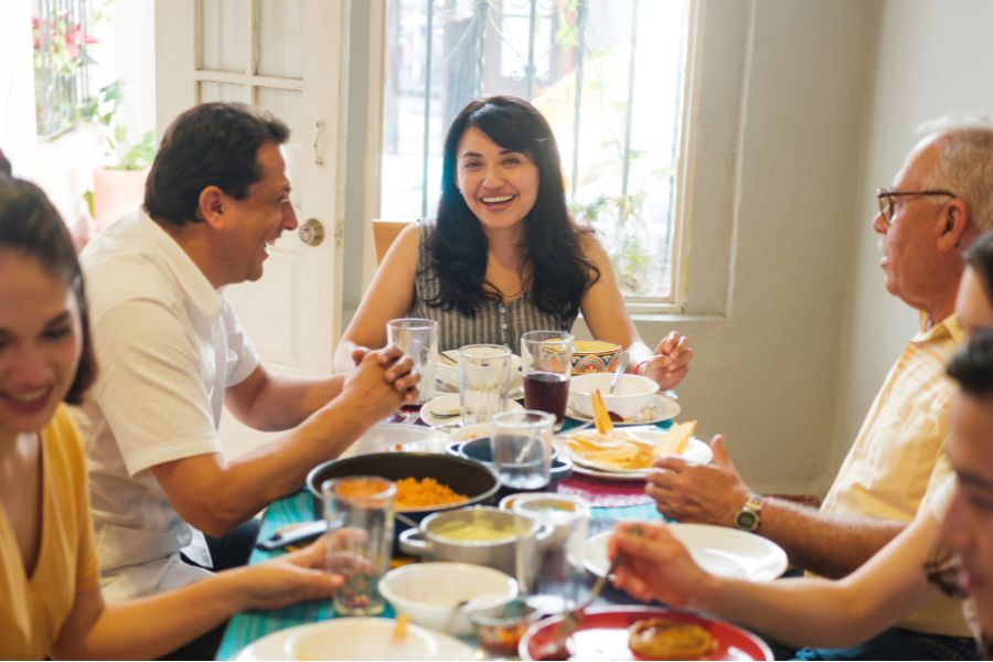 A family eating and talking together. 