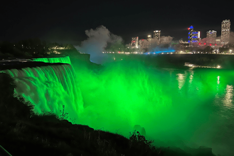 A photo of Niagara falls lit up green for Celiac Awareness Day.