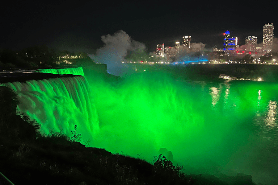 A photo of Niagara falls lit up green for Celiac Awareness Day. 