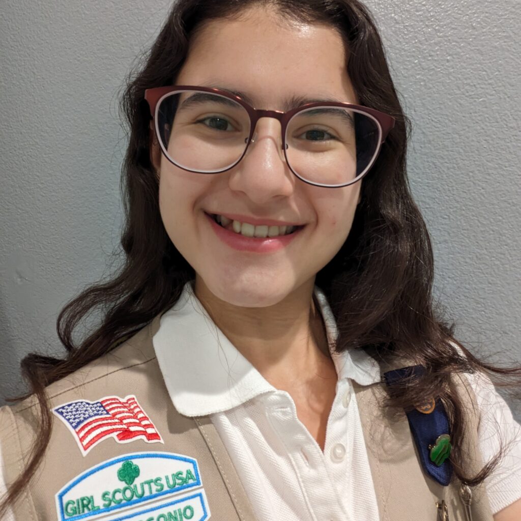 A photo of Sydnie smiling. She is wearing her Girl Scout vest.