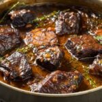A pan of short ribs in sauce.