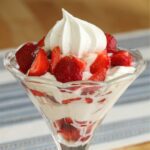 a glass of strawberry and meringue dessert.