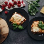 Two plates of lasagna.
