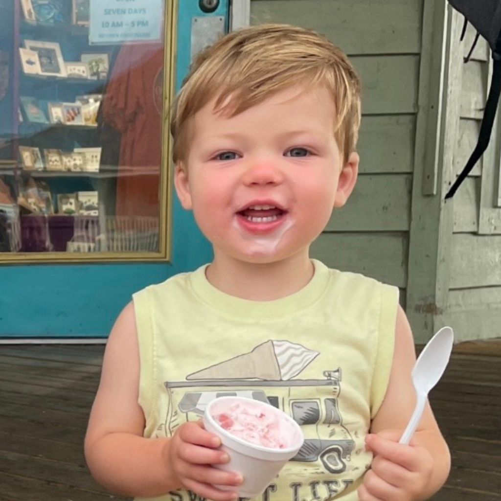 Gabriel eats ice cream in front of a bulding