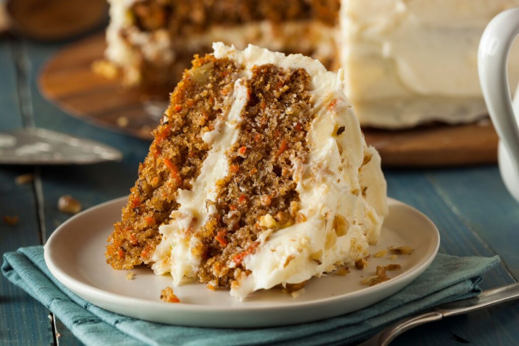 A piece of carrot cake with cream cheese frosting.