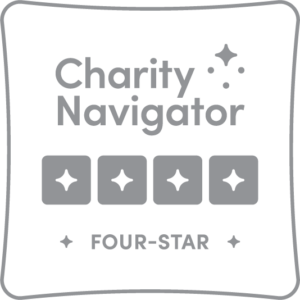 Charity Navigator four-star rating badge with four stars in a row and the words Charity Navigator Four-Star displayed prominently.