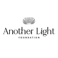 Logo for Another Light Foundation. The design features a black and white shell-like graphic above the words Another Light in large font, with FOUNDATION written in smaller capital letters below.